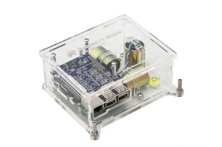 A Raspberry Shake 3D in a clear acrylic case, its three orthogonal geophones visible inside.